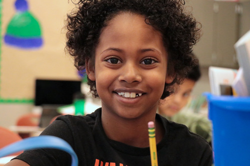 A student smiles at the camera